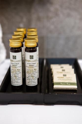 a black tray with three bottles of honey and a book at Casa Fochin tra Bormio e Livigno in Valdidentro