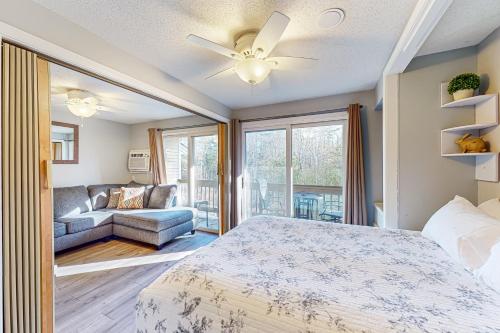 a bedroom with a bed and a couch at Misty Harbor Beach Retreat in Gilford