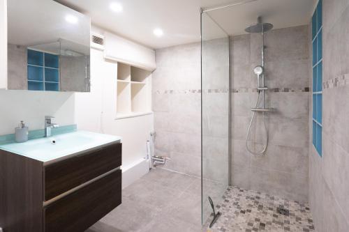 y baño con ducha y lavamanos. en Le Cocon d'Alesia ~ T3 Cosy Proche Ligne 4 Paris, en París