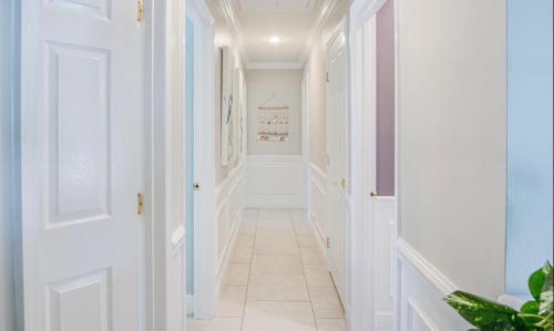 a hallway with white walls and a tile floor at Dolphin Cove in Cocoa Beach Fl in Cocoa Beach