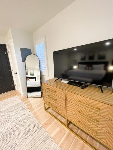 a living room with a large television on a wooden dresser at New Haven Inn in Solvang