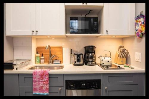 a kitchen with a sink and a microwave at 3BR Central Park in New York