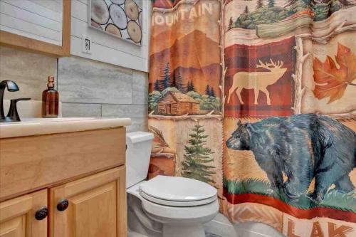 a bathroom with a bear shower curtain and a toilet at *Bear Hugs Chalet* SKI*Games *NewHotTub*Fire Pit in Lake Harmony