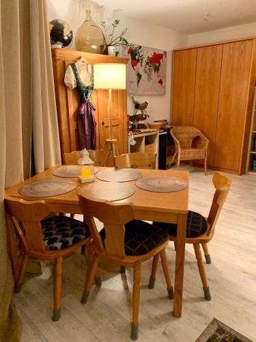 a dining room with a wooden table and chairs at FeWo Fuchs Saig in Lenzkirch