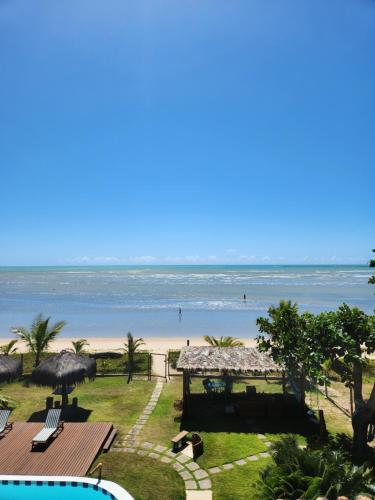 a view of the beach from the balcony of a resort at Pousada Mayon in Cumuruxatiba