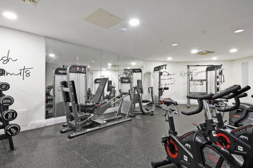 a gym with several treadmills and exercise bikes at City Centre Modern Studio Apartment - Westone FREE WIFI, GYM ACCESS, NETFLIX in Sheffield