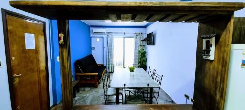 a hallway with blue walls and a table and chairs at Alon Ayun Centro Dpto 1 in Mendoza