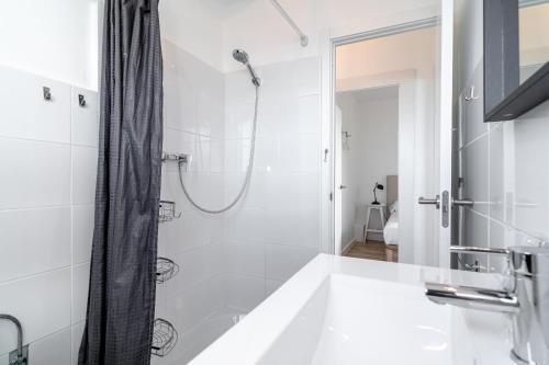 a white bathroom with a shower and a sink at Marina Vista Paradise Casasol in Nerja