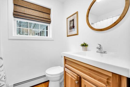 a bathroom with a sink and a mirror at Thomas Trail - Game Room, Fire Pit, 1 min to Ski Mountain & shared beach at Moose Pond! in Bridgton