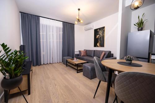a living room with a couch and a table at Belgrade Waterfront Cozy Symphony 2 in Sajmište