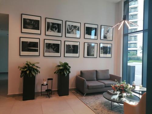 a living room with a couch and pictures on the wall at Belgrade Waterfront Cozy Symphony 2 in Sajmište