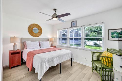 a bedroom with a bed and a ceiling fan at Beach Daze - Summer Sale! Southern Facing Pool, Walk To The Beach - No Ian Damage! in Naples
