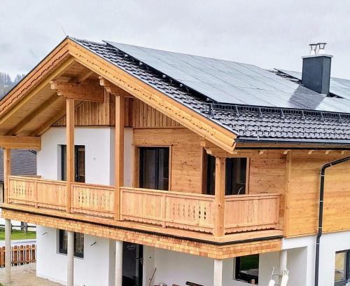 a house with solar panels on its roof at Apartments Haufhof , Haus im Ennstal bei Schladming in Haus im Ennstal
