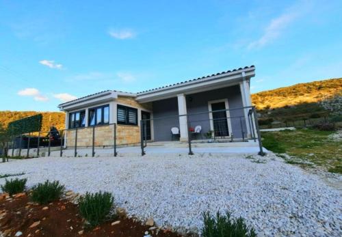 a small house with a fence in front of it at House Toni in Postira