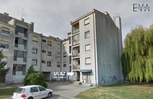a white car parked in front of a building at Apartman EVA - Dugo Selo / Zagreb in Dugo Selo