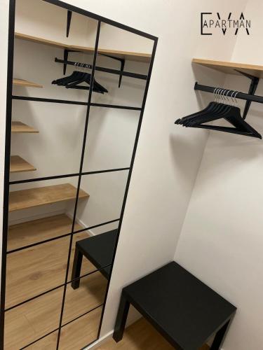 a mirror in a closet with a stool at Apartman EVA - Dugo Selo / Zagreb in Dugo Selo