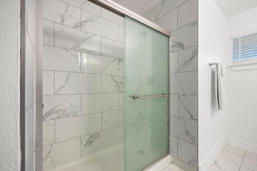 W łazience znajduje się prysznic ze szklanymi drzwiami. w obiekcie Austin Dunstan by Barclé w mieście Austin