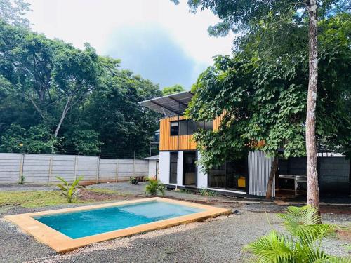 a house with a swimming pool in front of it at Villas Paraiso, Junquillal, Santa Cruz Desconectate en el Paraiso in Paraíso
