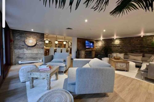 a large living room with couches and a tv at Exclusive 6 bed, 6 bath residence in Old Montreal in Montréal
