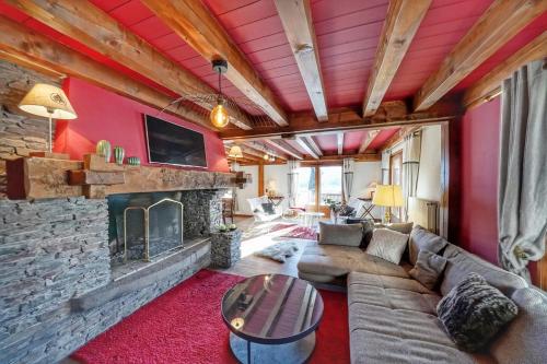 a living room with a couch and a fireplace at Pretty nest with view of Mont Blanc in Combloux