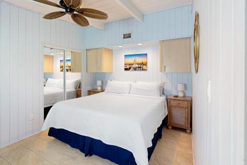Key Colony Beach的住宿－The Fisherman's Cottage，一间卧室配有一张大床和吊扇