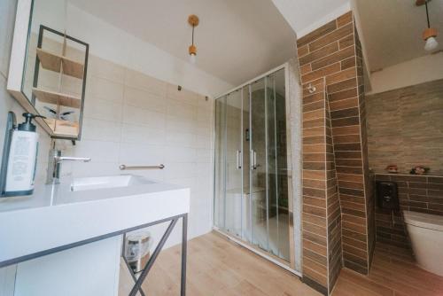 a bathroom with a glass shower and a sink at Casa della montagna apartament in Lorica
