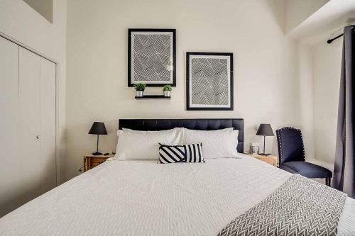 a bedroom with a large bed and two chairs at 2 Community Pools-Fully Stocked for Longer Stays in Mesa
