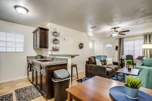 a kitchen and living room with a couch and a table at 2 Community Pools-Fully Stocked for Longer Stays in Mesa