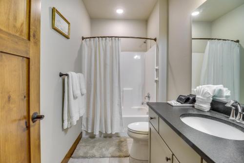 a bathroom with a sink and a toilet and a shower at Downtown Columbia Falls Condo 16 Mi to Ski Resort in Columbia Falls