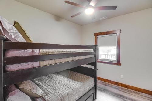 a bunk bed in a room with a ceiling fan at Downtown Columbia Falls Condo 16 Mi to Ski Resort in Columbia Falls