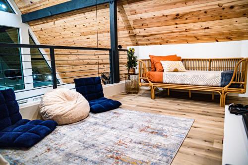 a room with a bed and a bench in a room at Gruene Daze Chalet - Stylish Aframe - Escape the Ordinary in New Braunfels