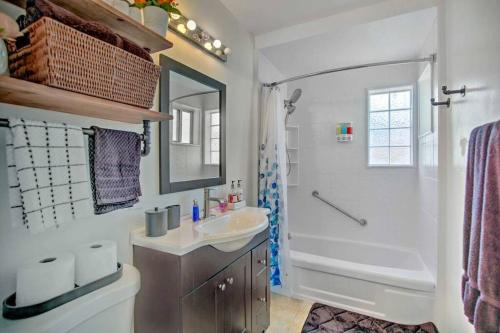 a white bathroom with a sink and a shower at Gorgeous Pacific Beach and Mission Bay Home. Walking distance to the Bay and Golf Course. in San Diego