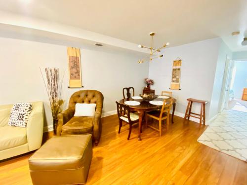 a living room with a couch and a table and chairs at Shanghai 2900 - Vintage Oriental Style 2BR w Parking near Airport in Philadelphia