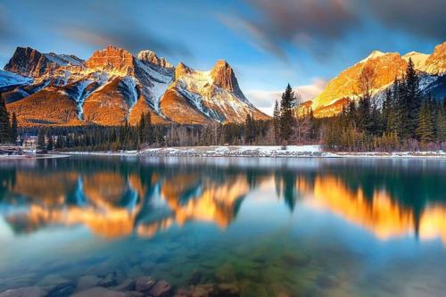 a view of a lake with mountains in the background at Luxury 3B Mountain Views- Pool & Hot Tub -Sleeps 10 in Canmore