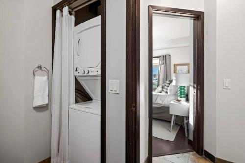 a bathroom with a mirror and a sink in a room at Luxury 3B Mountain Views- Pool & Hot Tub -Sleeps 10 in Canmore