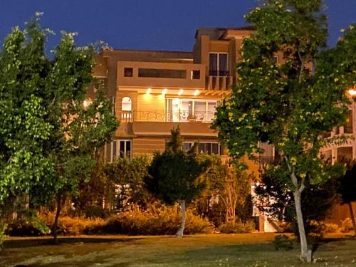 a large house with lights on the front of it at Maison 7 in El Obour