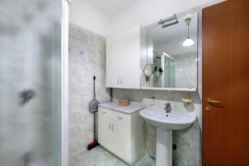 a bathroom with a sink and a mirror at Dogana Ponte Chiasso G e P 2 in Como
