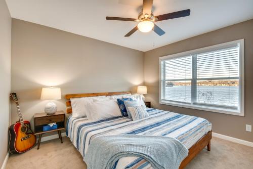 Luxe Pennsylvania Lakefront Vacation Rental! في Carbondale: غرفة نوم مع سرير ومروحة سقف وجيتار