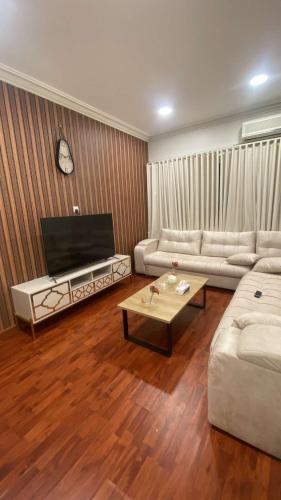 a living room with two couches and a coffee table at شقة مكونة من صالة وغرفة نوم in Al Hofuf