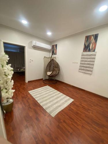 a living room with a hard wood floor and a fan at شقة مكونة من صالة وغرفة نوم in Al Hofuf