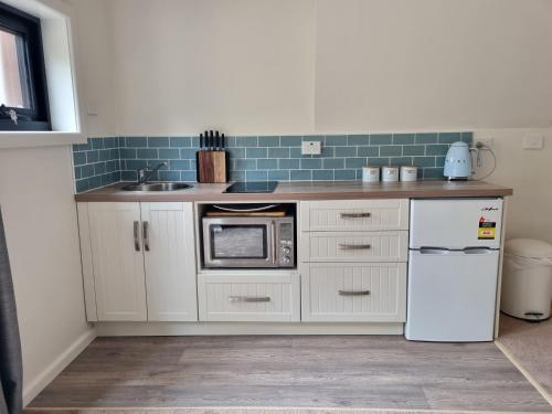 a kitchen with a white refrigerator and a sink at Lords Rest Apartment - Private and Central with Free Parking and Great WIFI in Hobart