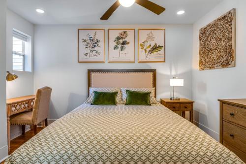 a bedroom with a bed with green pillows at Chic Indianapolis Home with Patio Less Than 2 Mi to Downtown in Indianapolis