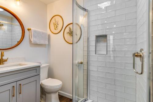 a bathroom with a shower and a toilet and a sink at Chic Indianapolis Home with Patio Less Than 2 Mi to Downtown in Indianapolis