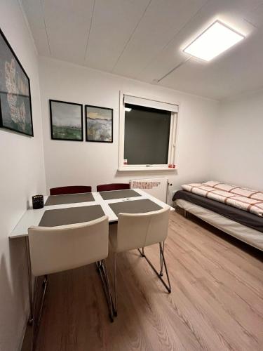 a room with a table and chairs and a bed at Shruti's Home in Billund