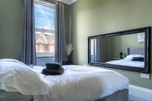 a bedroom with a bed and a large mirror at Hidden in plain sight in Kent