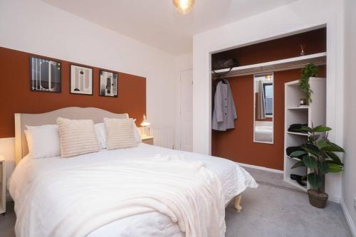 a bedroom with a large white bed and a window at Sleek Urban Living with Bicocca Stays in Aberdeen