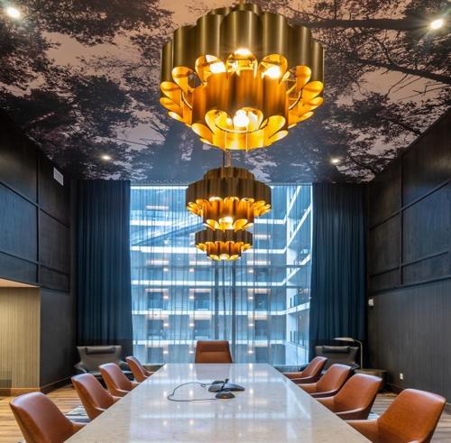 a conference room with a table and chairs and a chandelier at Hotel Indigo - Vancouver Dwtn - Portland Area, an IHG Hotel in Vancouver