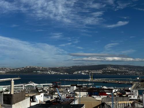 a view of a harbor with a city and the water at chez Abdou house with ocean view in Tangier