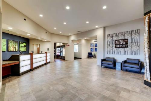 a large lobby with two chairs and a waiting room at Drury Plaza Hotel Denver Westminster in Westminster