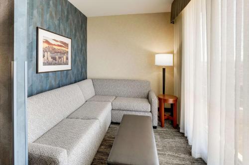 a living room with a couch and a table at Drury Plaza Hotel Denver Westminster in Westminster